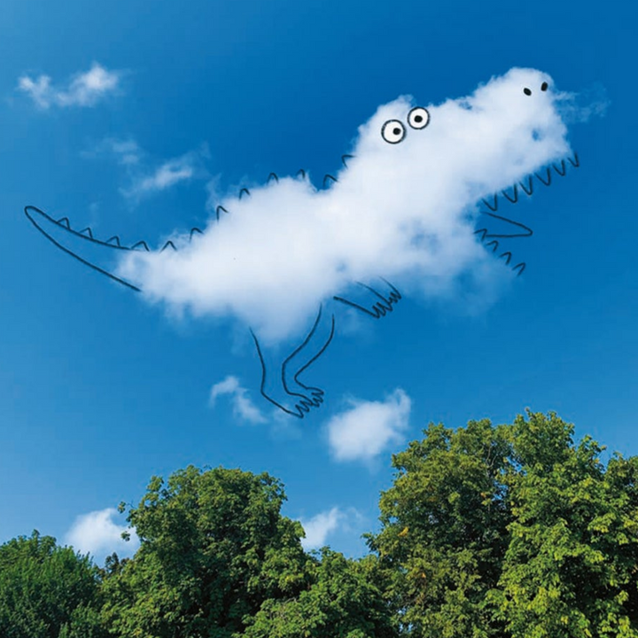 Cloud shaped like a dinosaur with eyes and mouth, against a blue sky with trees below.